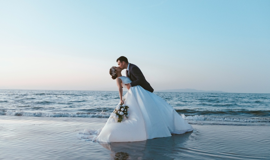 Couple sharing a romantic kiss by the sea in Mauritius