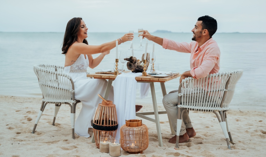 Romantic couple enjoying a candlelight dinner on the beach in Mauritius