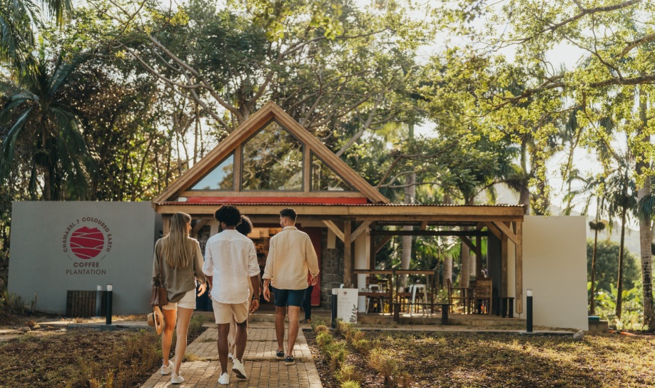 Visitors enjoying a coffee tour in Chamarel, Mauritius, surrounded by lush plantations and scenic landscapes