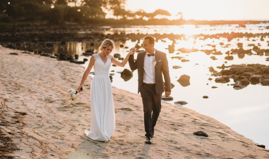 A young couple celebrating their sunset wedding on the beach at Veranda Pointe aux Biches, Mauritius