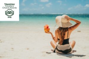 Woman on the beach at Veranda Resorts celebrating the 2025 Tripadvisor Awards in Mauritius.