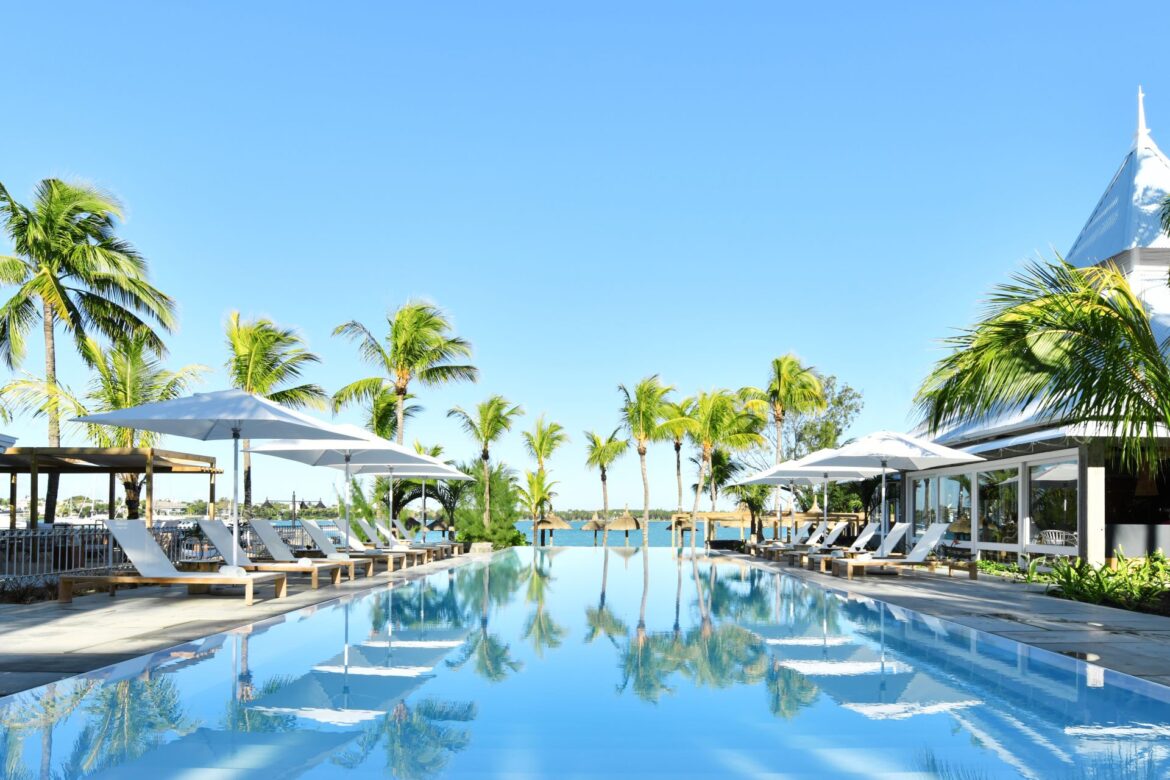 Exterior view of Veranda Grand Baie with the swimming pool surrounded by palm trees