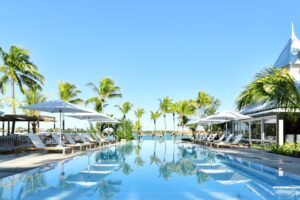 Exterior view of Veranda Grand Baie with the swimming pool surrounded by palm trees