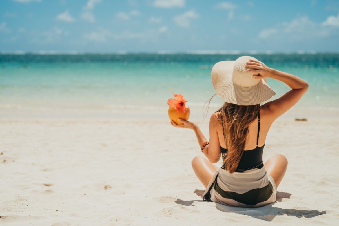 Woman on the beach celebrating the 2025 Tripadvisor Awards in Mauritius